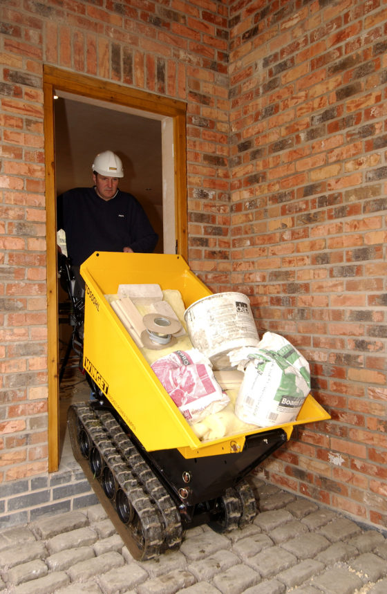 Man with trucked dumper leaving doorway